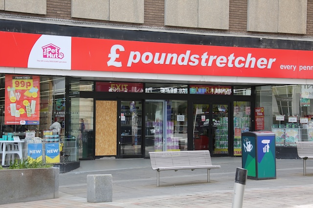 Poundstretcher with its door boarded up after the break in